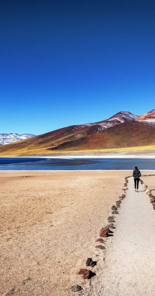Tourist enjoying the beautiful landscape of Atacama Desert in Ch
